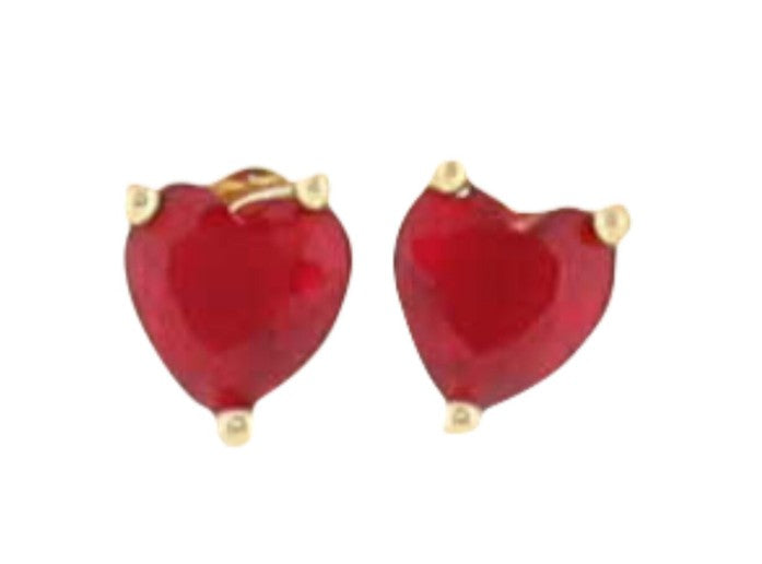 Photograph of heart-shaped stud earrings featuring vibrant ruby-red faceted stones secured by delicate three-prong yellow gold settings against a clean white background