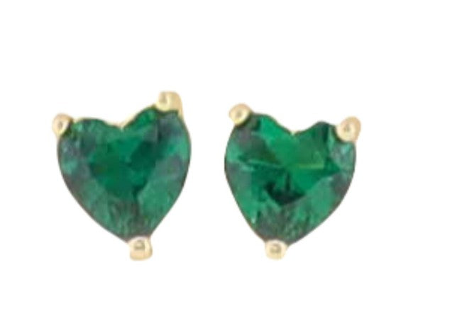Gold and gemstone jewelry heart-shaped stud earrings featuring vibrant faceted green stones secured in minimalist three-prong yellow gold settings against a plain white background