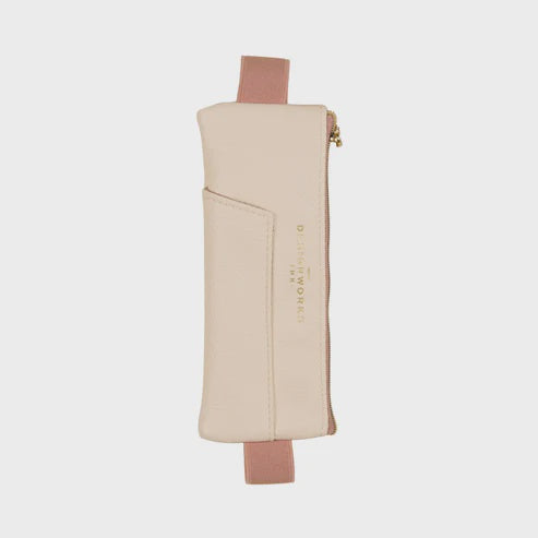 Vegan leather pencil pouch by Designworks Ink centered on a neutral background featuring a dusty rose elastic strap, a gold foil logo, and a front slip pocket
