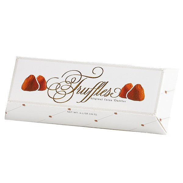 Product photograph of a white triangular prism gift box for Original Cocoa Truffles featuring elegant gold cursive calligraphy and colorful illustrations of cocoa-dusted chocolate sweets on a minimalist white background