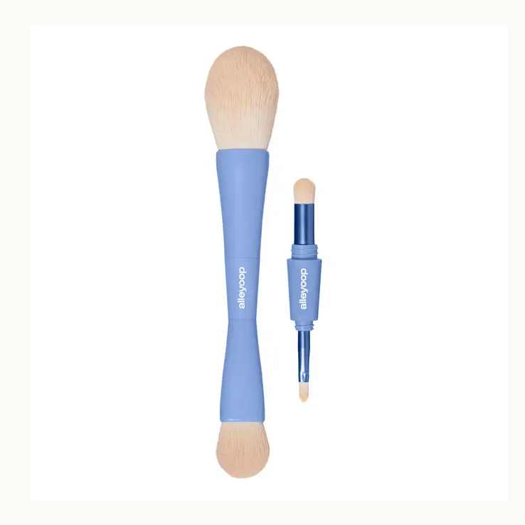 Product photograph by Alleyoop of a periwinkle blue 4-in-1 multi-tasking makeup brush set on a white background showcasing soft cream-colored bristles and the vertical white brand logo on the modular handle