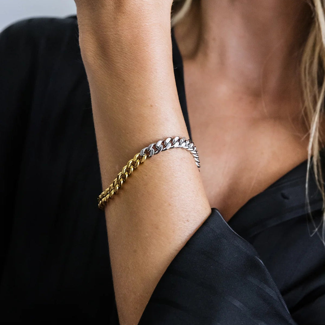 Professional photograph of a two-tone curb link bracelet on a woman&