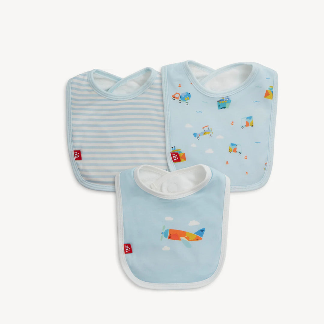 Product photograph of Mamas & Papas cotton baby bibs featuring a set of three on a white background with light blue stripes, a repeating transport pattern, and a large central orange propeller plane with signature red brand tags
