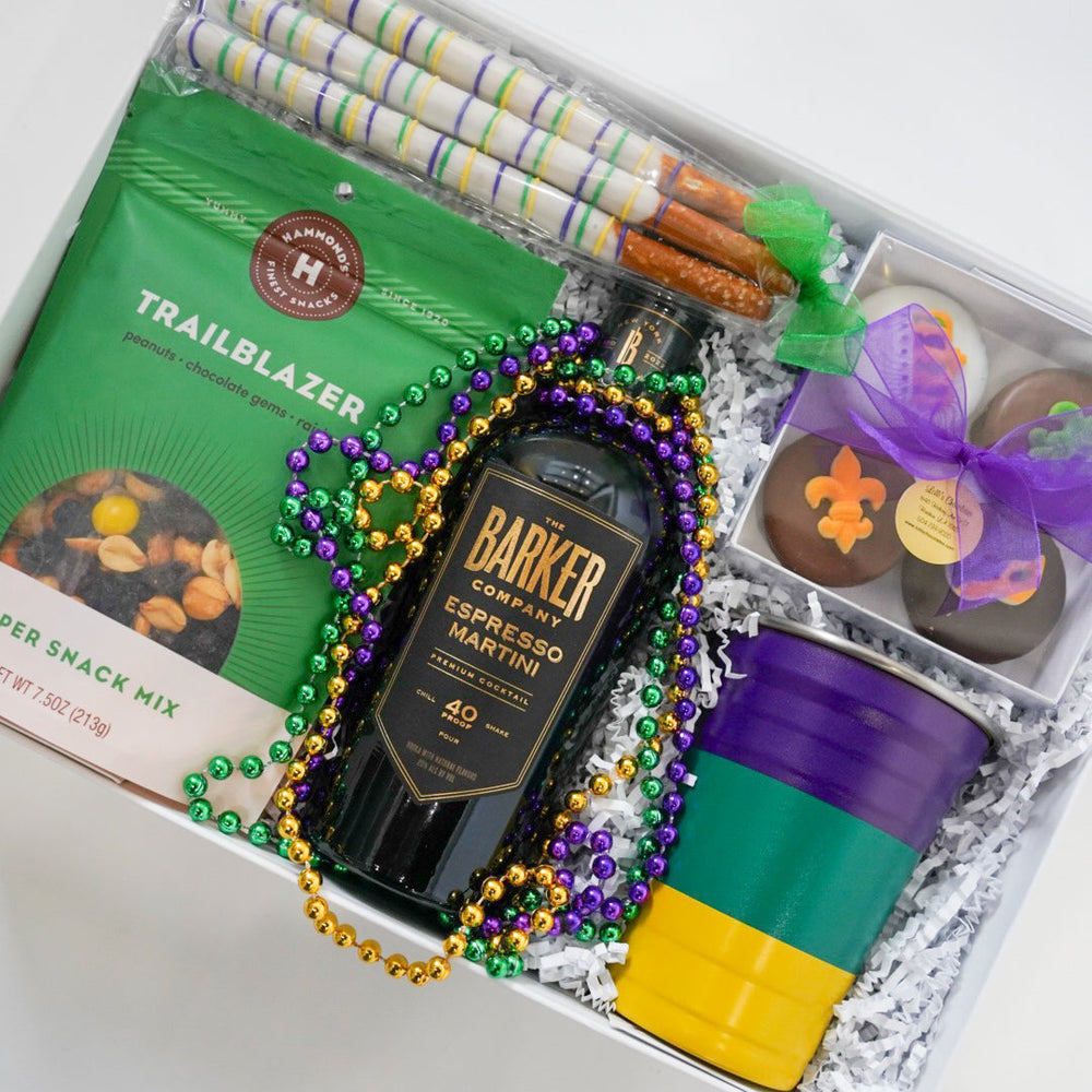 Gift box with a bottle of liquor, snacks, and decorative items on a white background