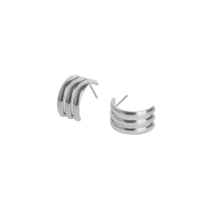 Polished silver metal triple-banded earrings centered on a white background featuring three parallel curved ridges with a high-shine finish and thin stud posts