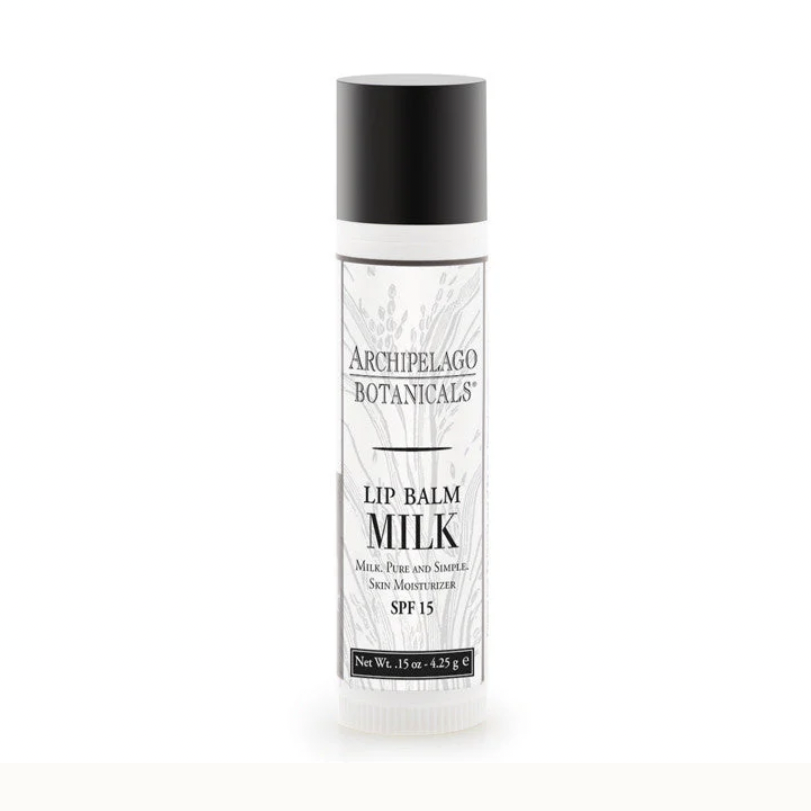 Product photograph by Archipelago Botanicals of a Milk Lip Balm tube on a white background featuring the brand logo, a matte black cap, and intricate grey botanical patterns with bold SPF 15 text