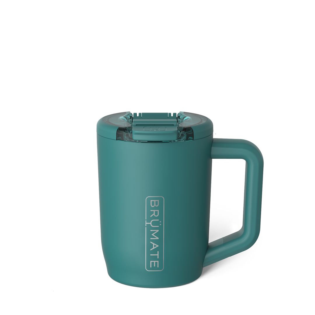 Digital product photograph by BrüMate of a matte teal insulated travel mug on a white background highlighting its vertical silver logo, translucent leak-proof lid, and integrated square handle