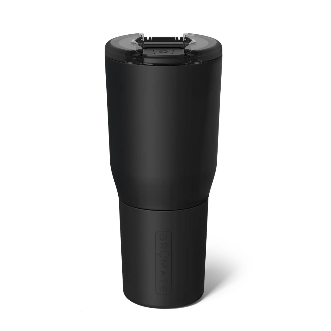 Product photograph by BrüMate of a matte black insulated tumbler against a white background featuring a clear leak-proof lid with a black flip-top latch and a vertically embossed logo on the tapered base