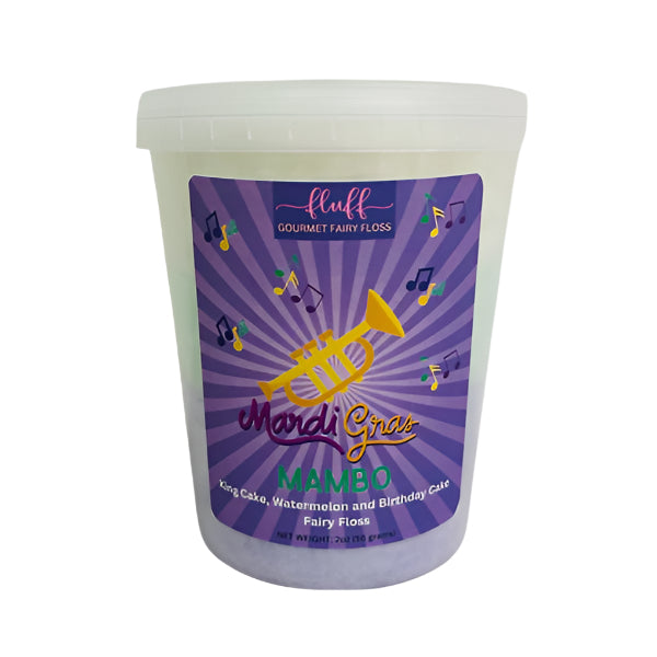 Commercial product photography of fluff Gourmet Fairy Floss featuring a Mardi Gras Mambo tub against a white background with a purple sunburst label, a golden trumpet, and layers of mint green and purple cotton candy