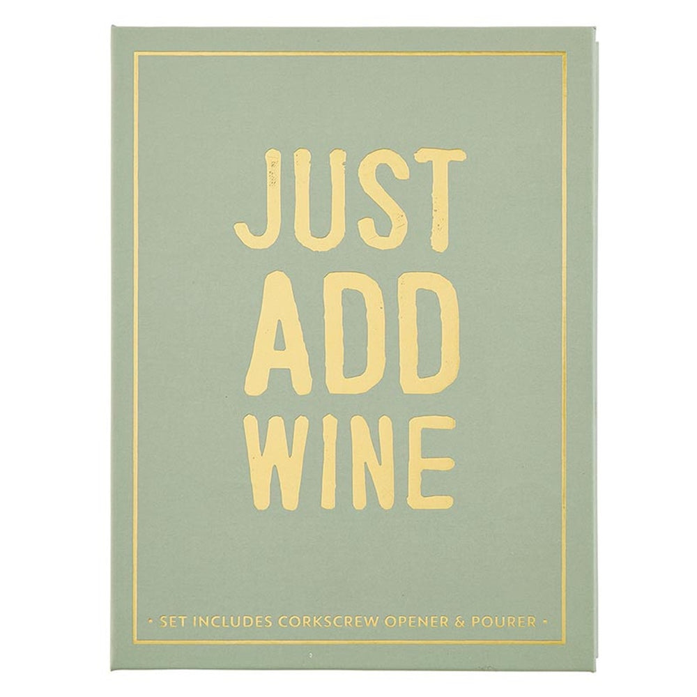 Graphic design on a sage green book-shaped gift box featuring bold gold foil typography reading JUST ADD WINE centered within a thin gold border with distressed lettering and subtext listing included wine accessories