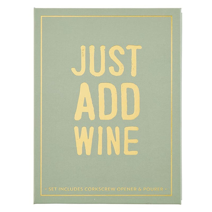 Graphic design on a sage green book-shaped gift box featuring bold gold foil typography reading JUST ADD WINE centered within a thin gold border with distressed lettering and subtext listing included wine accessories
