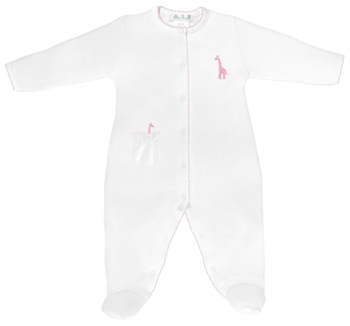 Product photograph of a Lyda Baby white footie on a white background featuring integrated feet, a pink embroidered giraffe on the chest, a ruffled pocket, and delicate pink scalloped trim along the snap-front closure
