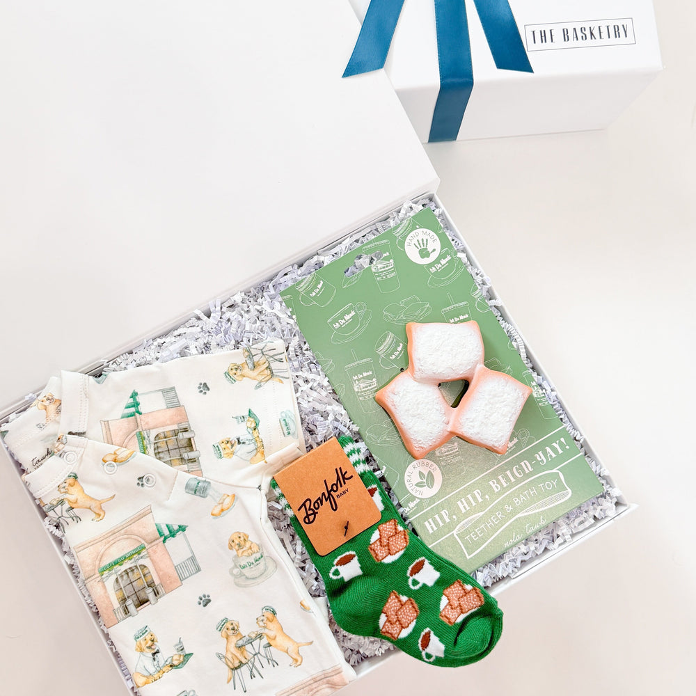 Gift box with a blue ribbon, a card, and a small green bag on a white background