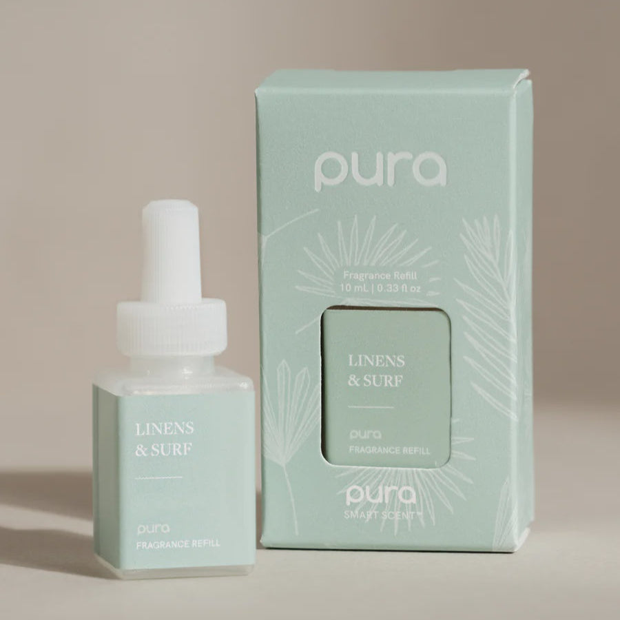 Digital product photography for Pura featuring a Linens & Surf fragrance refill bottle and its sage green box decorated with white palm leaf illustrations against a minimalist beige backdrop