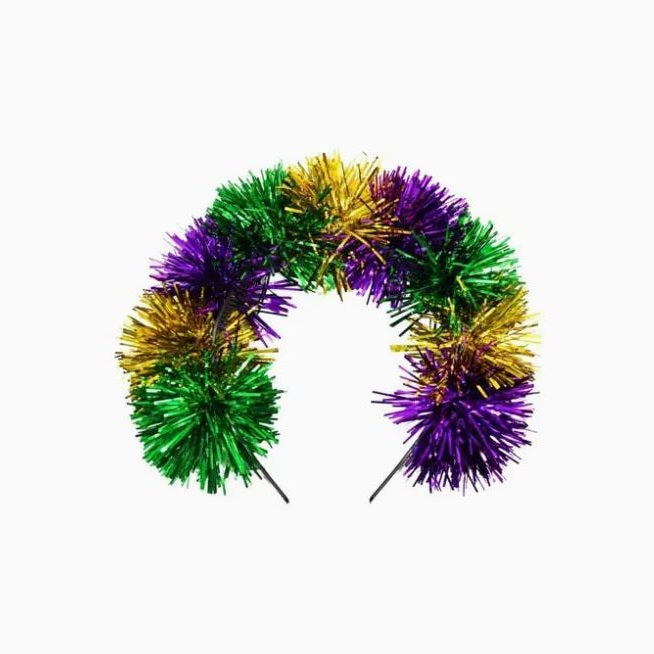 Product photograph of a festive Mardi Gras tinsel headband featuring shimmering purple, green, and gold metallic tufts arranged in a thick decorative arc against a solid white studio background