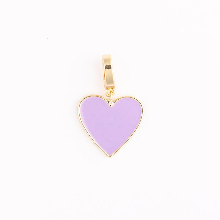 Gold-toned jewelry pendant featuring a lavender enamel heart with a polished metallic border and a rectangular bail centered against a bright white background