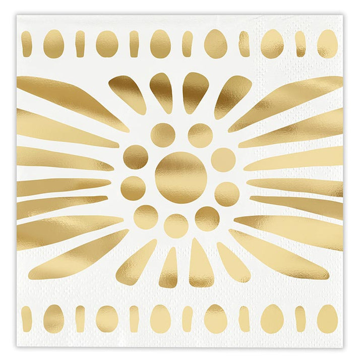 Gold foil graphic on white textured paper napkin featuring a central abstract sunburst motif with radiating metallic teardrop shapes and horizontal borders of alternating golden ovals and dots