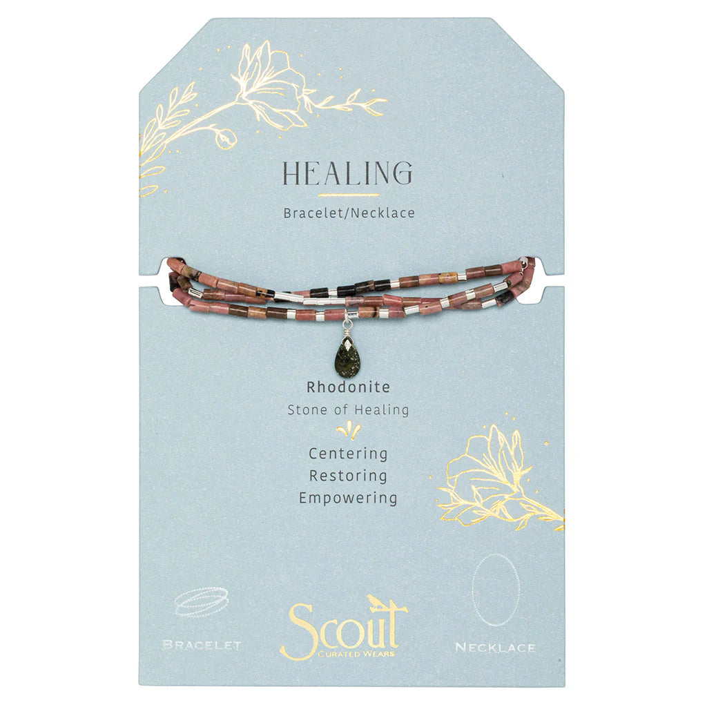 Jewelry by Scout Curated Wears featuring a rhodonite stone bracelet and necklace on a light blue card with the Scout logo, a dark green teardrop pendant, and gold foil floral accents