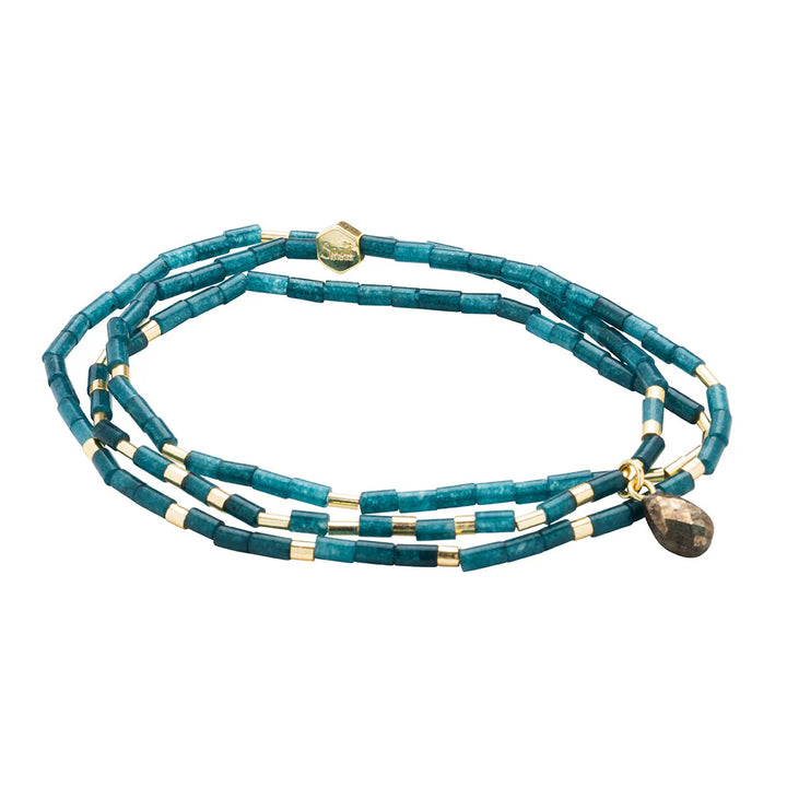 Handcrafted jewelry by Satya Jewelry featuring a multi-strand wrap bracelet of teal cylindrical apatite beads accented with small gold spacers and a dangling faceted bronze-toned teardrop charm against a white studio background