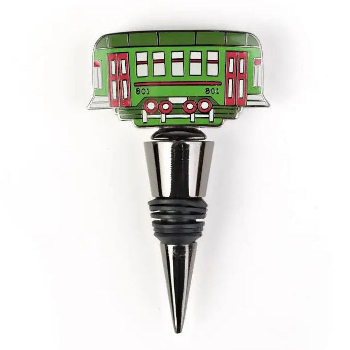 Enamel and metal wine bottle stopper featuring the iconic St. Charles Avenue streetcar from New Orleans with a vibrant green body, red double doors, and identifying number 801 atop a polished silver-toned base