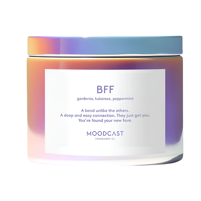 Product photograph of a Moodcast Fragrance Co. BFF scented candle featuring a glass jar with a shimmering iridescent holographic finish, a minimalist white label with purple typography, and a matching flat lid against a white studio background