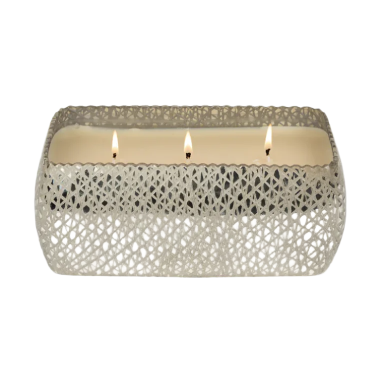 Hand-poured scented candle featuring three glowing wicks set in a rectangular cream wax base encased in an intricate silver-toned lattice mesh vessel against a minimalist white background