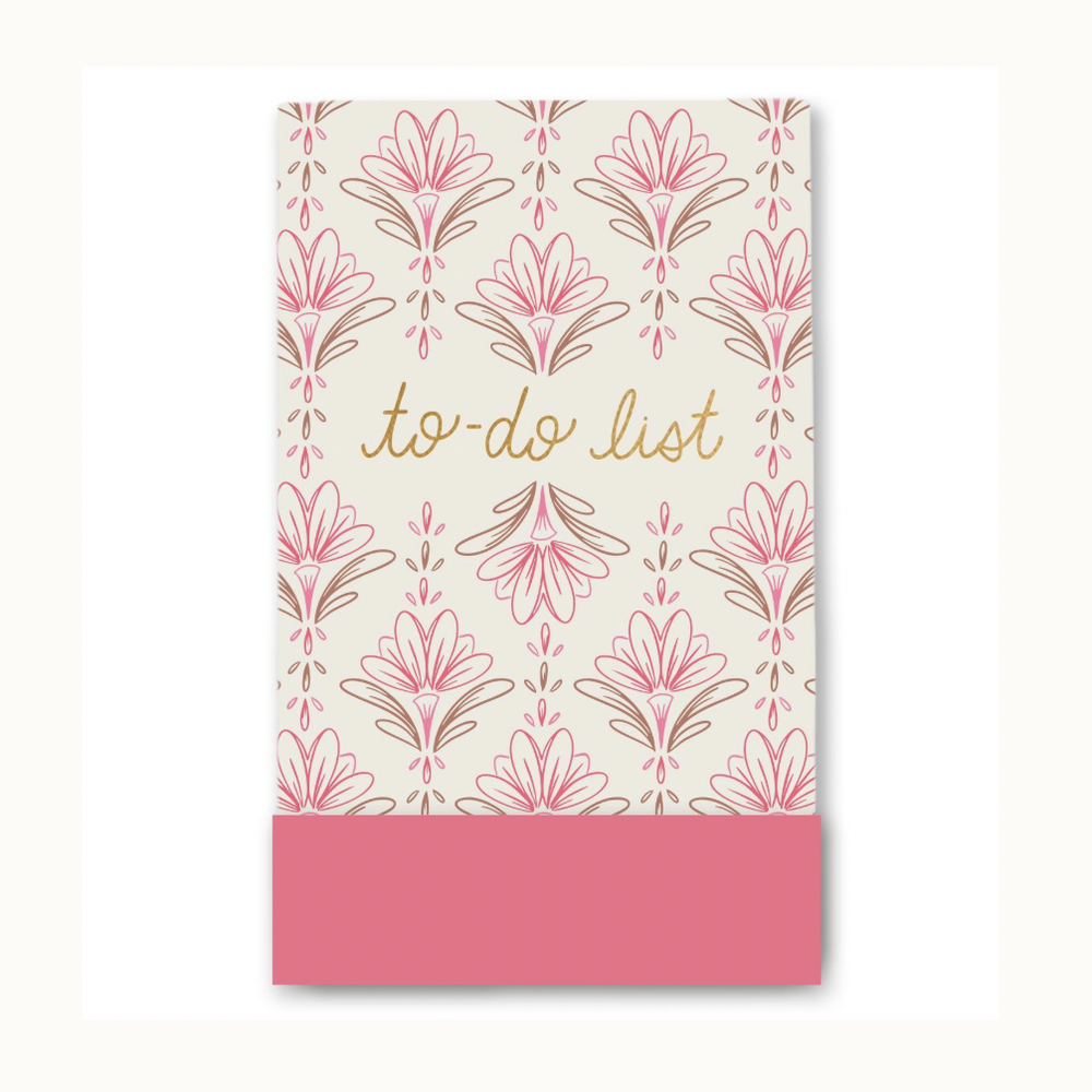 Graphic design to-do list notepad featuring elegant gold cursive script, a repeating pattern of pink and bronze stylized flowers, and a solid rosy-pink block at the bottom
