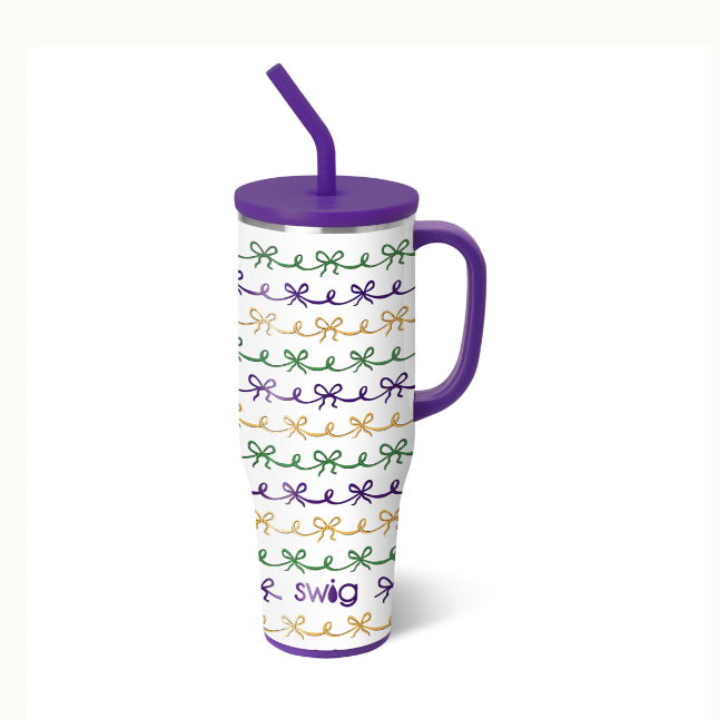 Insulated stainless steel tumbler by Swig Life featuring a Mardi Gras pattern of repeating purple, green, and gold bows with a matching purple handle, reusable straw, and the Swig logo at the base