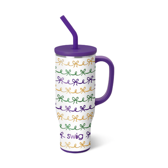 Commercial product photography by Swig Life of a Mardi Gras themed insulated Mega Mug on a white background featuring a purple handle and straw with a repeating pattern of gold green and purple ribbon bows