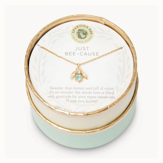 18kt gold plated necklace by Spartina 449 featuring a bee pendant with a seafoam green stone and crystal-studded wings displayed inside a round gift box with the brand's mermaid logo and Just Bee-Cause inscription