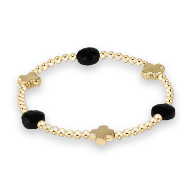 Gold beaded bracelet by an unknown designer featuring three polished gold cross charms and three faceted black gemstone beads interspersed with reflective spherical metallic spacers on a white background