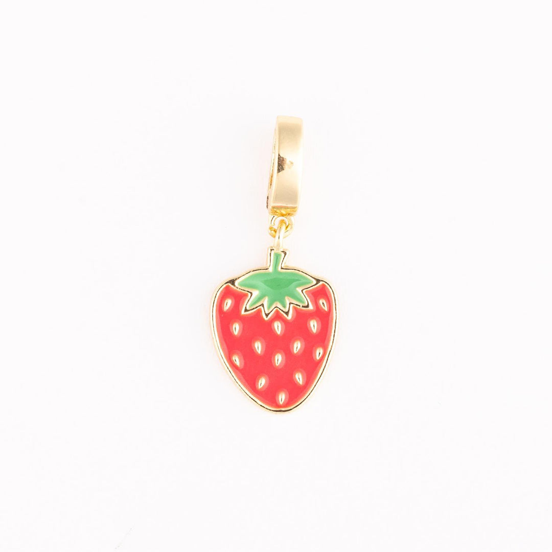 Gold-plated enamel jewelry charm featuring a vibrant red strawberry with small gold-toned seeds and a green leafy top isolated on a crisp white background