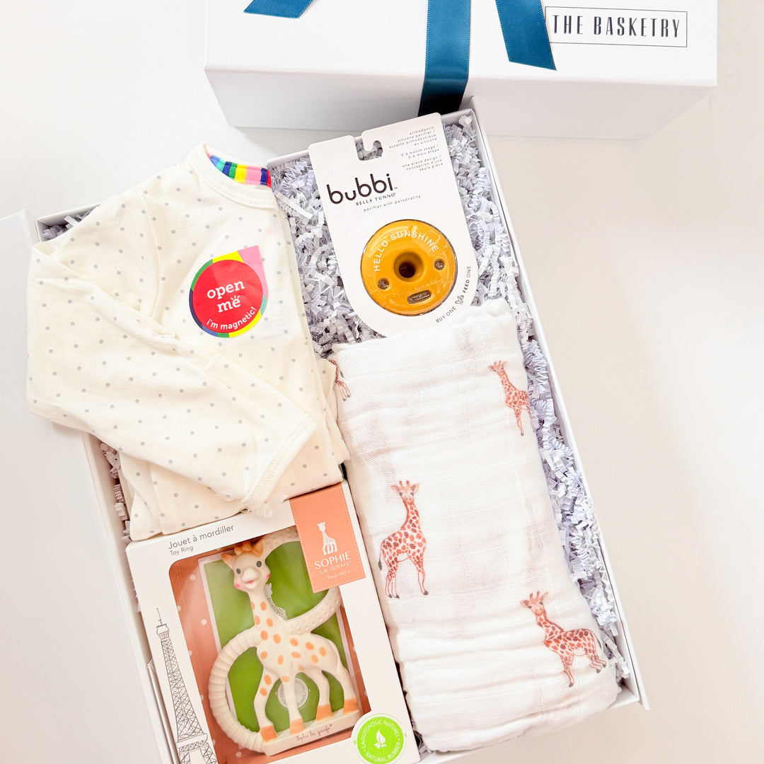 Baby gift set with burp cloth, bib, and box on a white background
