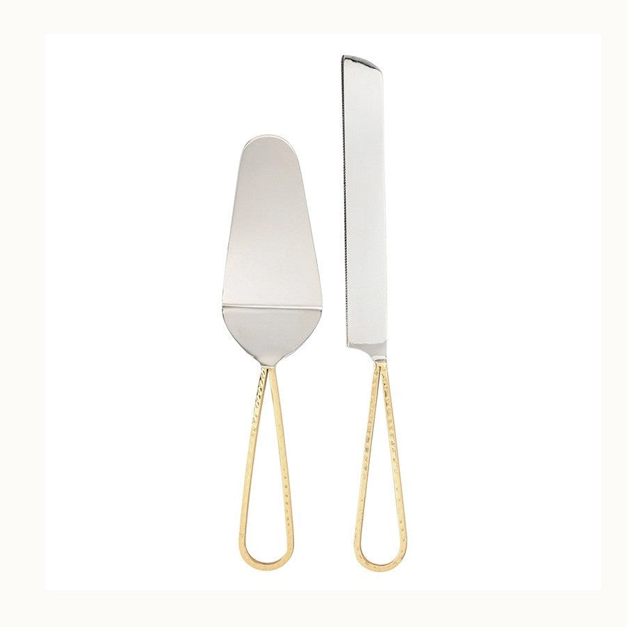 Polished stainless steel cake serving set featuring a server and serrated knife with elegant hammered gold-tone teardrop handles against a minimalist white background