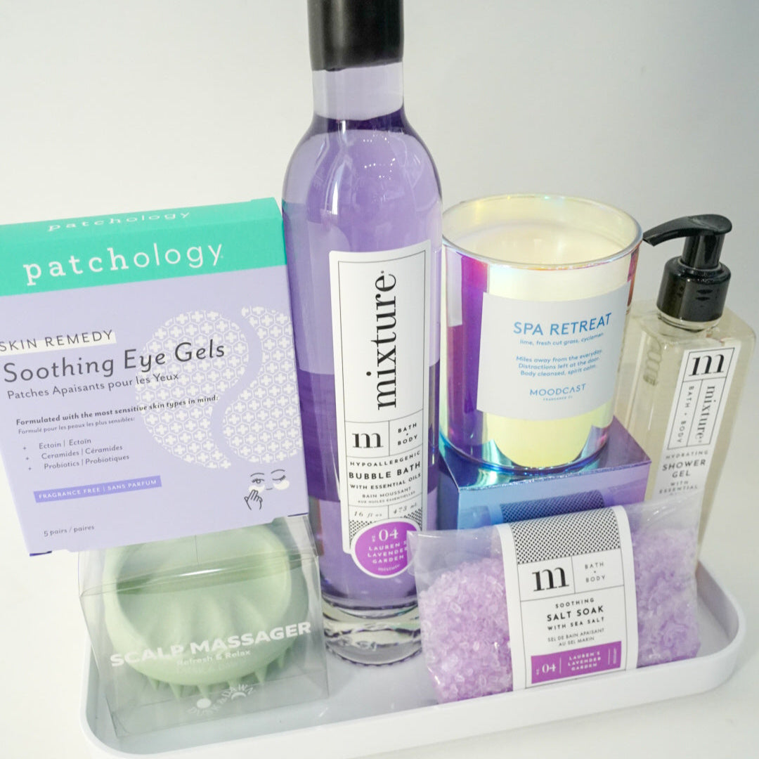 Collection of skincare and wellness products on a tray with a white background