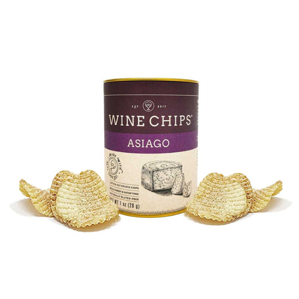 Product photograph by Wine Chips of an Asiago flavored snack canister on a white background featuring the brand's circular logo, golden-brown lattice-cut potato chips, and a hand-drawn illustration of an asiago cheese wheel on a dark purple label