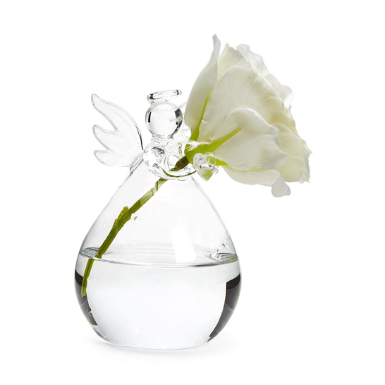 Hand-blown clear glass angel vase featuring delicate wings and a halo, holding a white blossom with a green stem in a water-filled teardrop base against a minimalist white background