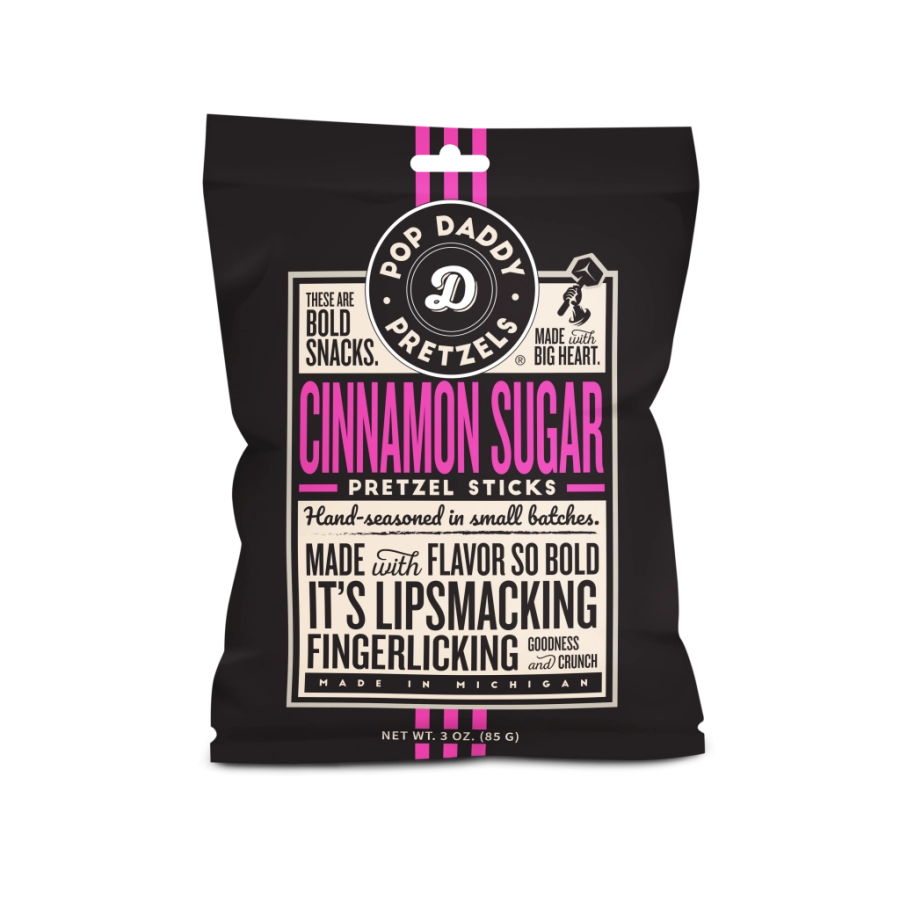 Graphic design for Pop Daddy Pretzels of a snack bag for Cinnamon Sugar Pretzel Sticks from Michigan featuring vibrant pink typography, a circular white logo, and vertical pink stripes on a black background