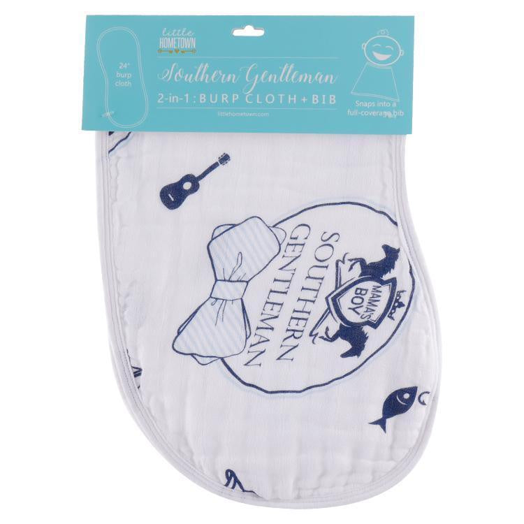 Little Hometown muslin 2-in-1 burp cloth and bib set against a white background features a Southern Gentleman theme with navy blue illustrations of an acoustic guitar, a pinstriped bow tie, and a Mama's Boy fox crest