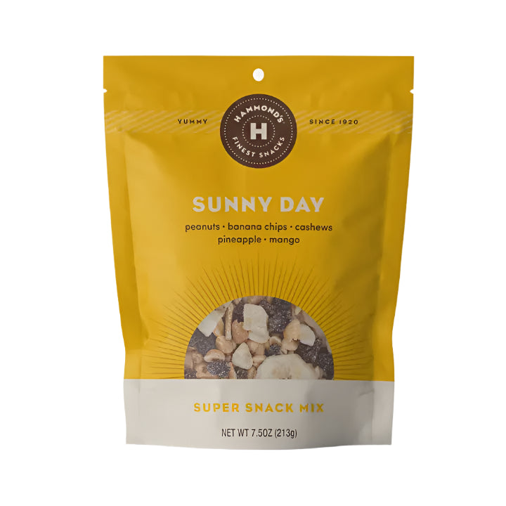 Product photograph of Hammond's Candies Sunny Day Super Snack Mix featuring a vibrant yellow stand-up pouch with a circular sunburst window revealing dried fruit and nuts positioned below a dark brown brand seal