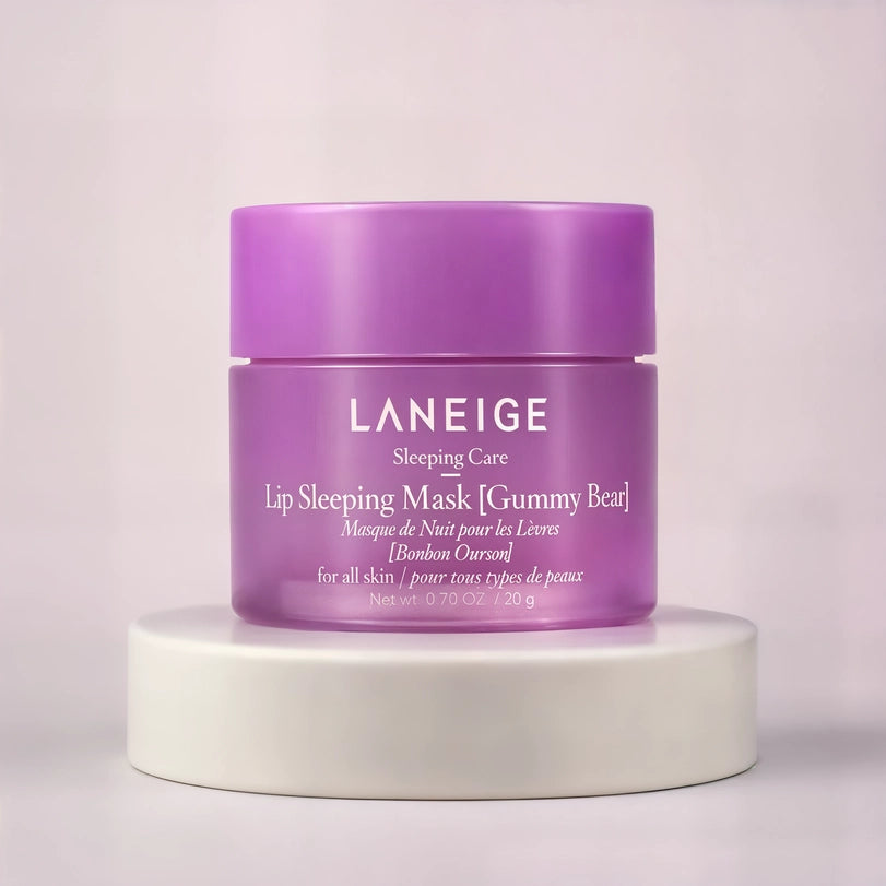Commercial studio photography for LANEIGE featuring a vibrant purple jar of Gummy Bear Lip Sleeping Mask centered on a white circular pedestal against a soft lavender backdrop with crisp white branding details