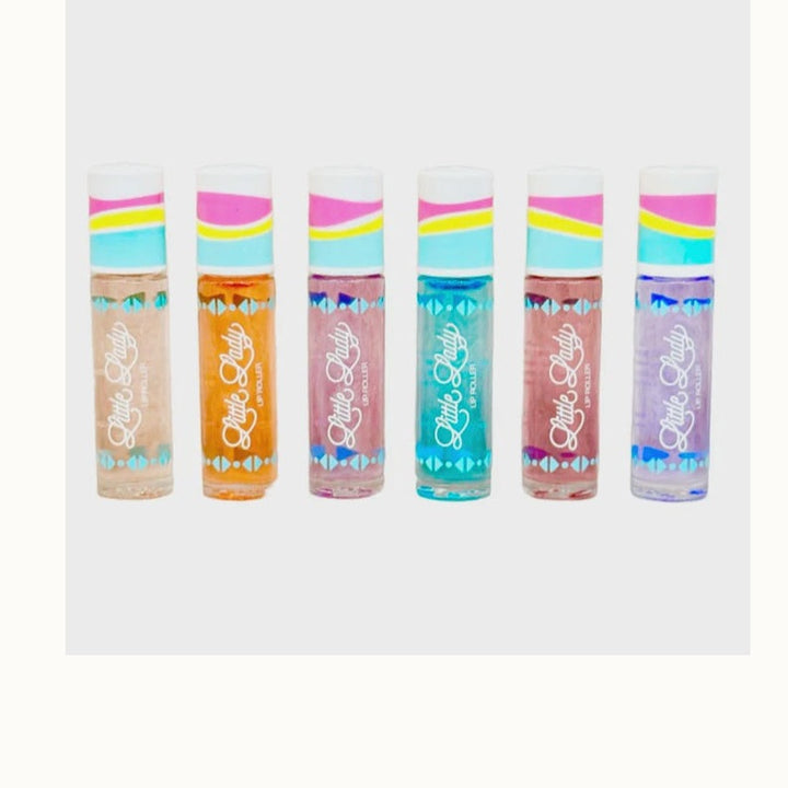 Product photography for Little Lady features six shimmering lip roller tubes in a row on a white background showcasing vibrant shades of teal and orange with colorful wavy striped caps and a distinct white script logo