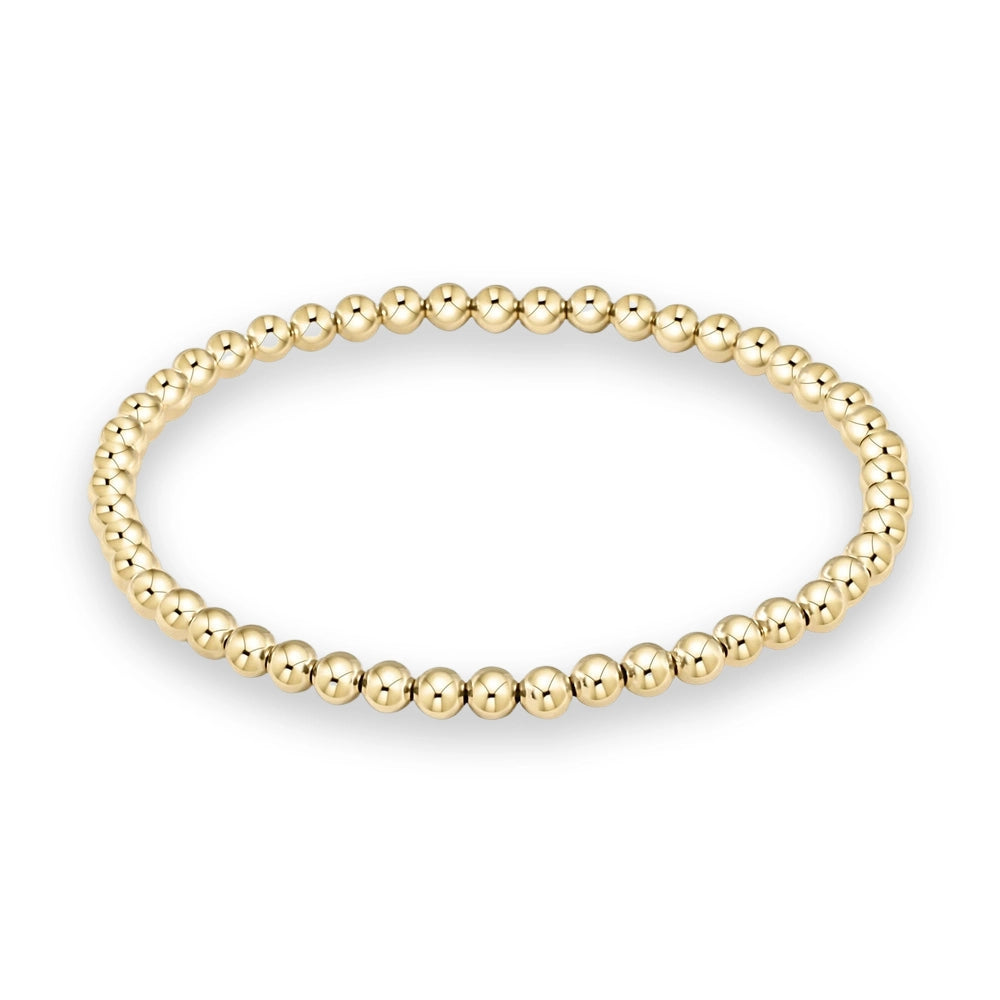 Polished yellow gold bead bracelet showcasing a seamless arrangement of uniform spherical beads with a high-shine reflective finish on a minimalist white background