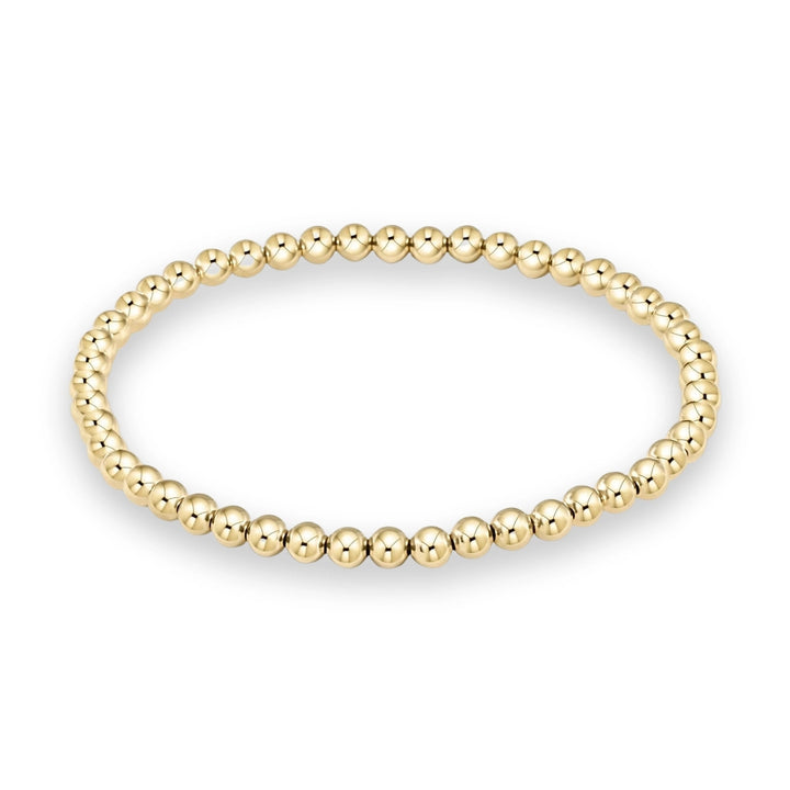 Polished yellow gold bead bracelet showcasing a seamless arrangement of uniform spherical beads with a high-shine reflective finish on a minimalist white background