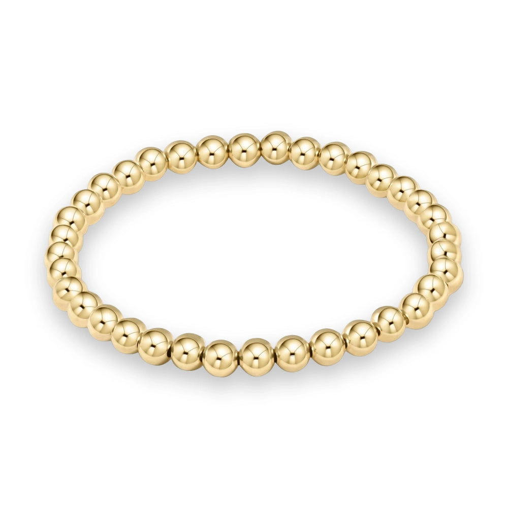 Yellow gold jewelry piece featuring a circular strand of polished spherical beads with a high-reflectivity mirror finish against a plain white background