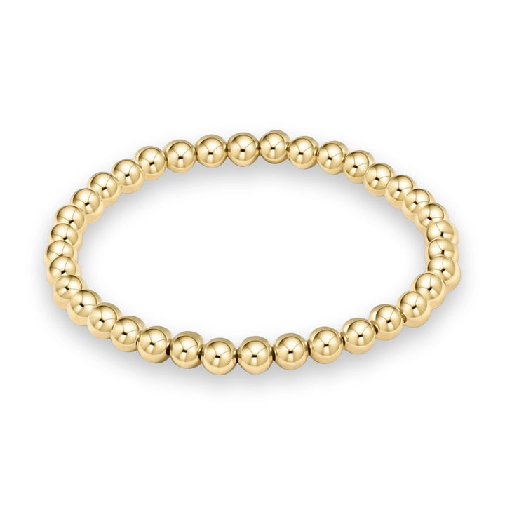Yellow gold jewelry piece featuring a circular strand of polished spherical beads with a high-reflectivity mirror finish against a plain white background