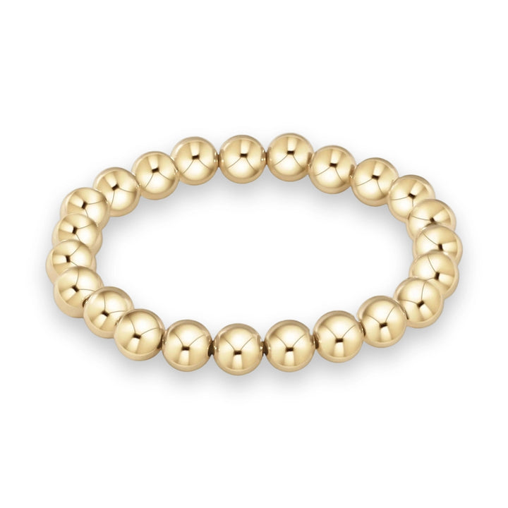 Gold bead bracelet on a white background featuring polished spherical beads with a bright metallic luster and high-shine reflective finish
