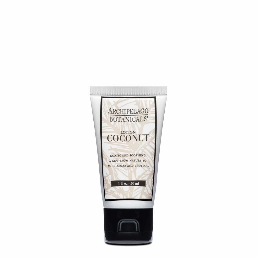 Commercial product photograph of Archipelago Botanicals Coconut Lotion presented in a travel-sized white tube with a beige palm leaf motif, black serif branding, and a glossy black flip-top cap against a neutral white background