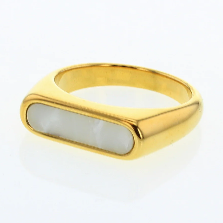 Gold jewelry signet ring featuring an elongated rectangular white pearlescent inlay and a high-polish finish on a reflective white background