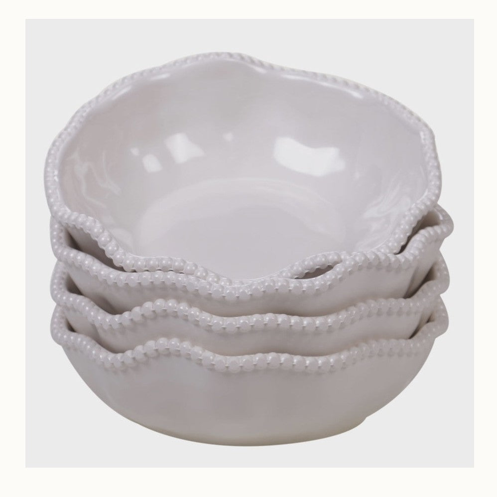 Ceramic stoneware stack of four nested bowls featuring wavy scalloped edges with raised beaded trim and a glossy white glaze against a neutral background